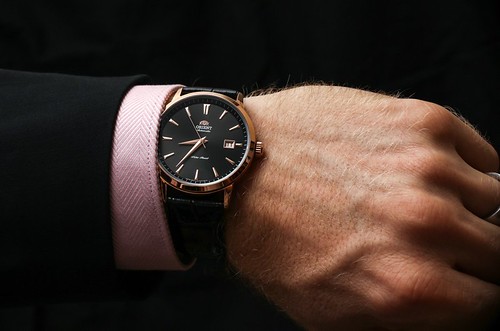 black luxury watch on mans wrist